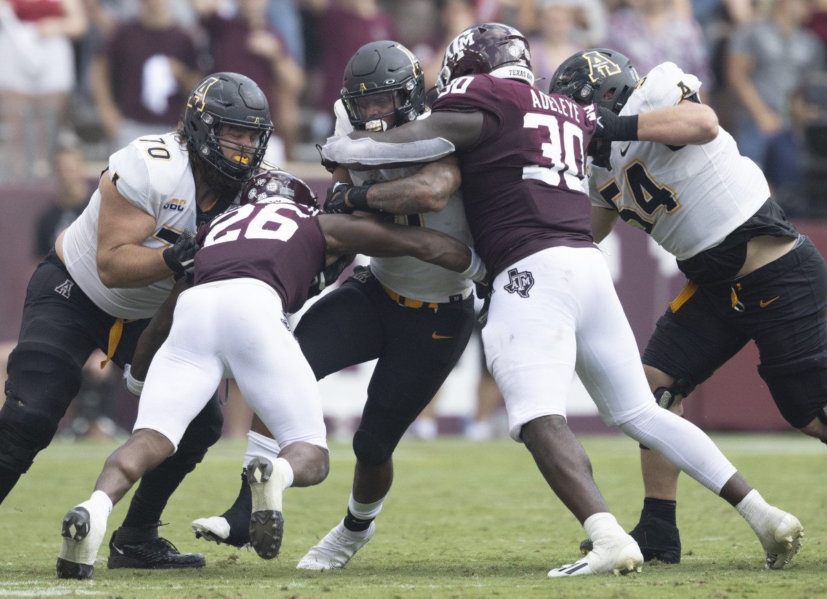Sep 10, 2022; College Station, Texas, USA; Appalachian State Mountaineers running back Camerun Peoples (6) rushes against Texas A&M Aggies defensive lineman Tunmise Adeleye (30) in the second quarter at Kyle Field. Mandatory Credit: Thomas Shea-USA TODAY Sports